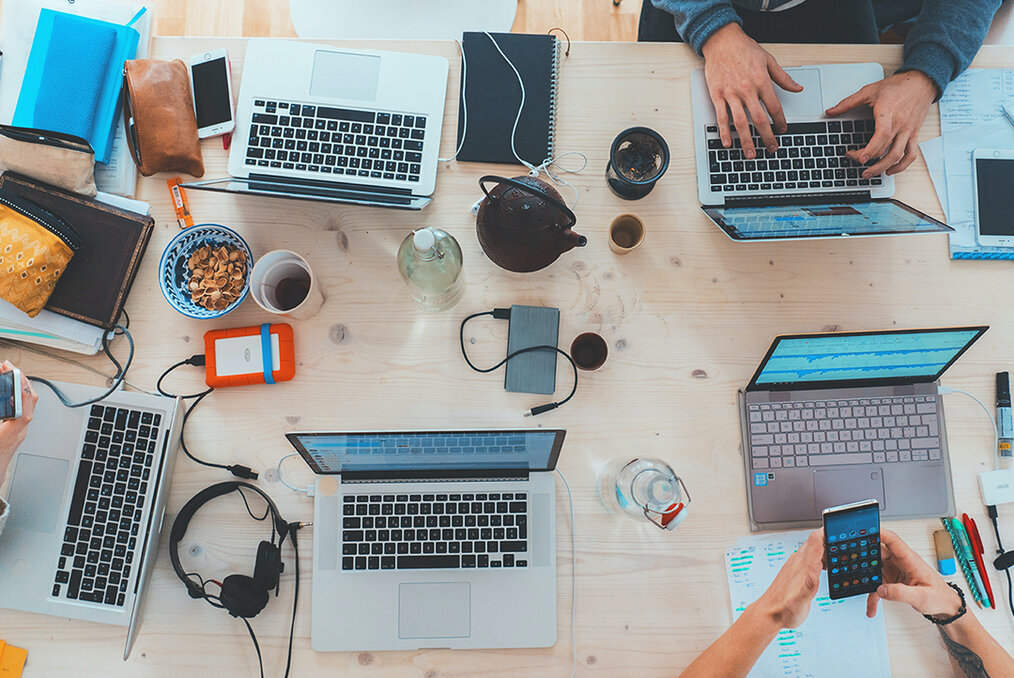 A Birdseye view of a table filled with computers and tech gear